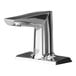 A T&S WaveCrest polished chrome sensor faucet with a 4" modern edge spout on a white counter.