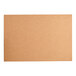 A close-up of a rectangular brown cardboard surface.