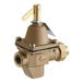 A close-up of a brass Watts feed water pressure regulator valve with a gold handle.