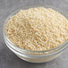 A bowl of McCormick Culinary White Sesame Seeds on a table.