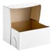 A Wilton white cardboard bakery box with the lid open.