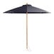 A Lancaster Table & Seating indigo blue umbrella with a wooden pole.