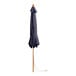 A closed Lancaster Table & Seating indigo blue umbrella on a wooden pole.