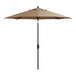 A tan umbrella on a black stand.