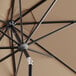 A close up of a Lancaster Table & Seating black and tan umbrella.