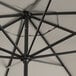 A close up of a Lancaster Table & Seating black umbrella with a metal pole.