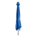 A Lancaster Table & Seating cobalt blue cantilever umbrella on a metal pole with a white band.