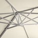 The metal structure of a Lancaster Table & Seating ivory cantilever umbrella.