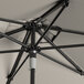 A close up of a Lancaster Table & Seating black aluminum umbrella on a table.