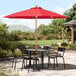 A Lancaster Table & Seating strawberry umbrella on a patio table.