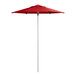 A red Lancaster Table & Seating umbrella on a metal pole.