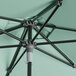 A close up of a Lancaster Table & Seating black aluminum umbrella with a metal pole.