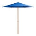 A blue umbrella with a wood pole.