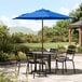 A Lancaster Table and Chairs with a Blue Umbrella.