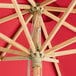 A Lancaster Table & Seating bamboo umbrella with a pulley lift.