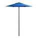 A blue Lancaster Table & Seating umbrella on a black pole.