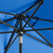 A blue Lancaster Table & Seating umbrella with a black metal pole.