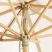 A Lancaster Table & Seating white bamboo umbrella with a pulley lift.