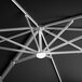 A close-up of a Lancaster Table & Seating black cantilever umbrella with a metal structure and lights.