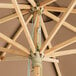 A Lancaster Table & Seating wooden umbrella with a pulley lift.