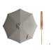 A Lancaster Table & Seating grey bamboo umbrella with a wooden pole.