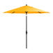 A yellow Lancaster Table & Seating umbrella on a black stand.