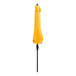 A yellow Lancaster Table & Seating umbrella on a black pole.
