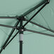 A close up of a Lancaster Table & Seating black aluminum umbrella with a black pole.