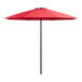 A close up of a red Lancaster Table & Seating umbrella with a white background.
