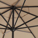 A close up of a black Lancaster Table & Seating umbrella with a crank lift.