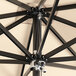 A close up of a black Lancaster Table & Seating square umbrella with a metal pole.