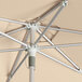 A Lancaster Table & Seating round silver aluminum umbrella open on a metal pole.