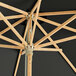 A Lancaster Table & Seating bamboo umbrella with a black pulley lift.