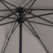 A close up of a Lancaster Table & Seating black umbrella with a metal pole.