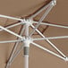 A close up of a Lancaster Table & Seating wheat round umbrella with a silver pole.