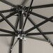 A close up of a Lancaster Table & Seating black aluminum umbrella with metal poles.