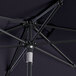 A close up of a navy blue Lancaster Table & Seating round umbrella with a black pole.