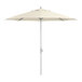 A Lancaster Table & Seating ivory umbrella with a silver pole.