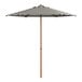 A Lancaster Table & Seating black and white striped umbrella with woodgrain pole.