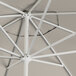 A white umbrella with a silver metal pole.