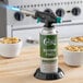 A Choice adjustable butane torch on a black base with a green and white canister.
