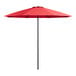 A close up of a red Lancaster Table & Seating umbrella with black poles.