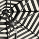 A Lancaster Table & Seating black and white striped umbrella with a black metal pole.