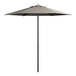 A close up of a grey Lancaster Table & Seating umbrella with a black pole.