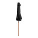 A black umbrella on a woodgrain pole with a strap.