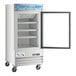 An Avantco white glass door merchandiser freezer with the door open.