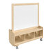 A wooden mobile double-sided art station with white boards and shelves.