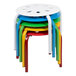 A stack of colorful Flash Furniture plastic stools.