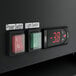 The electronic switch panel on a black Avantco GDC-9F-HC glass door freezer.