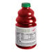 A close-up of a Dr. Smoothie Organic Strawberry Banana Fruit Smoothie Mix bottle filled with red liquid.